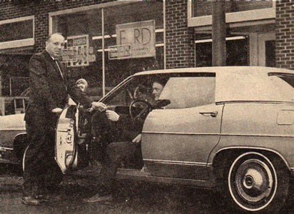 A customer collecting a new Ford outside the Fostoria store