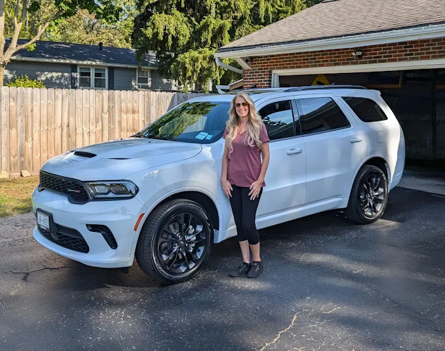 A customer beside her Dodge Durango on collection day