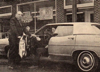 Archive photograph of a customer collecting a car outside the original showroom