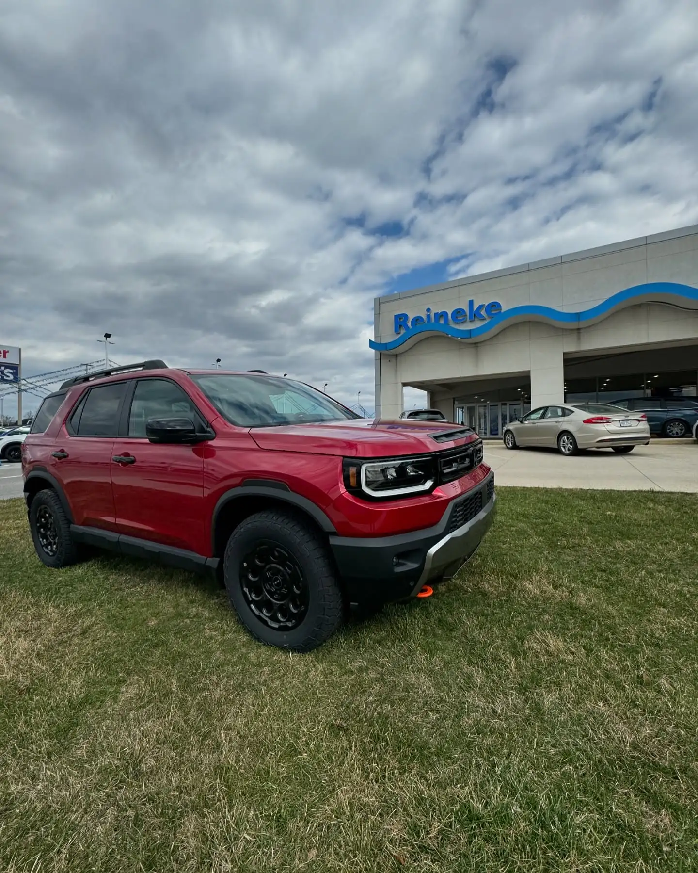 A red Ford Bronco Sport outside a Reineke dealership