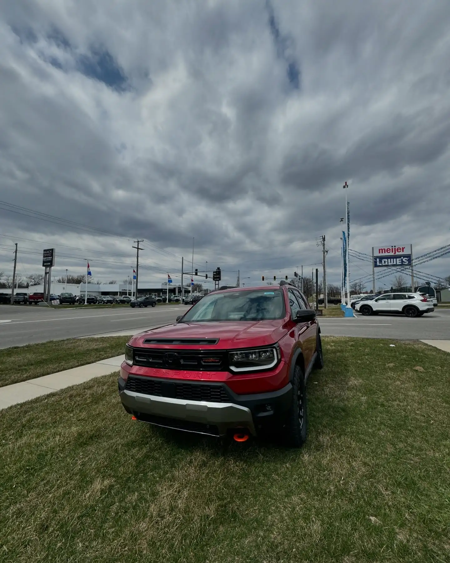A red Ford Bronco Sport on the forecourt