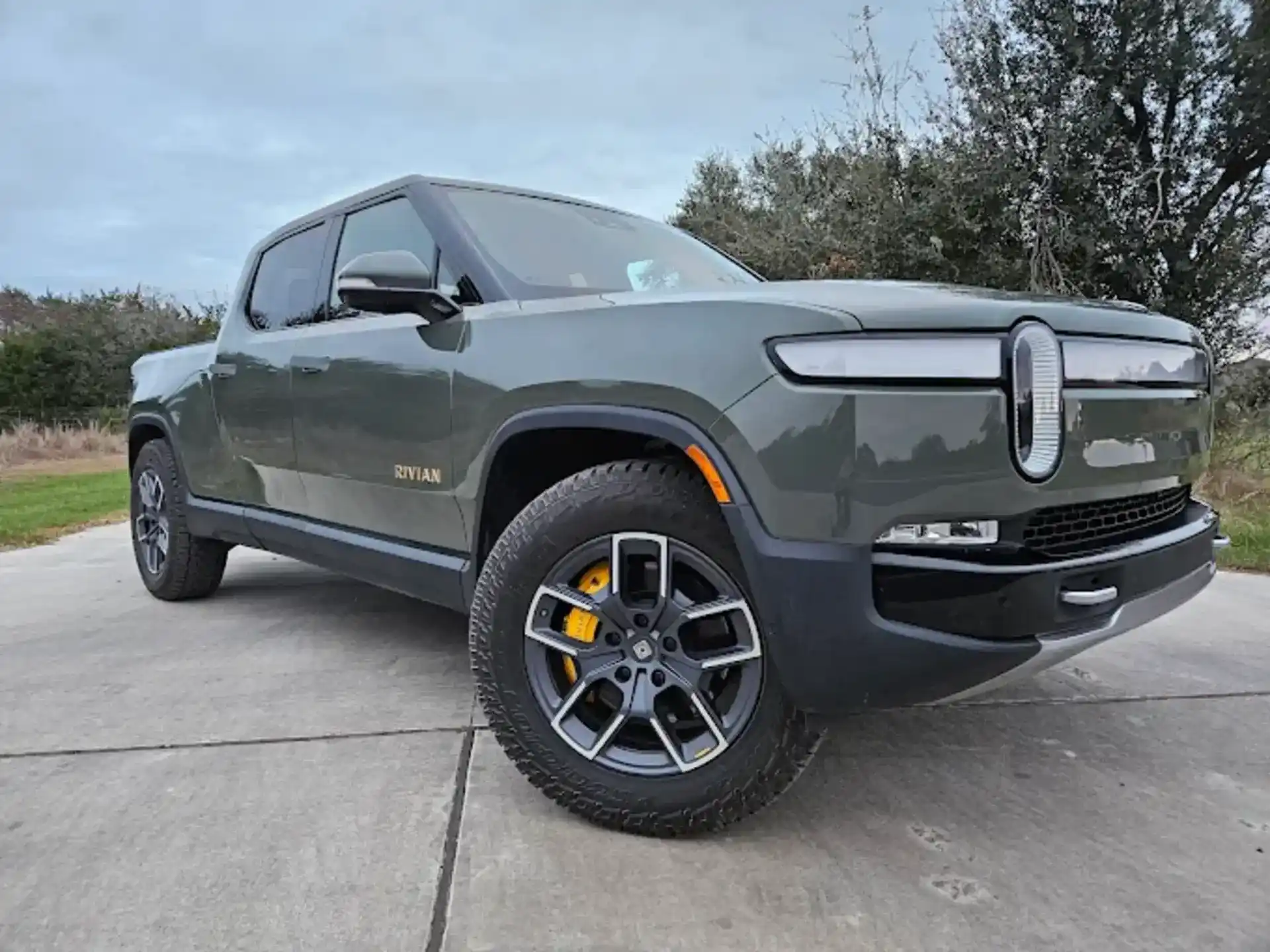 A Rivian pickup on a driveway, one of the many vehicle types Reineke buys